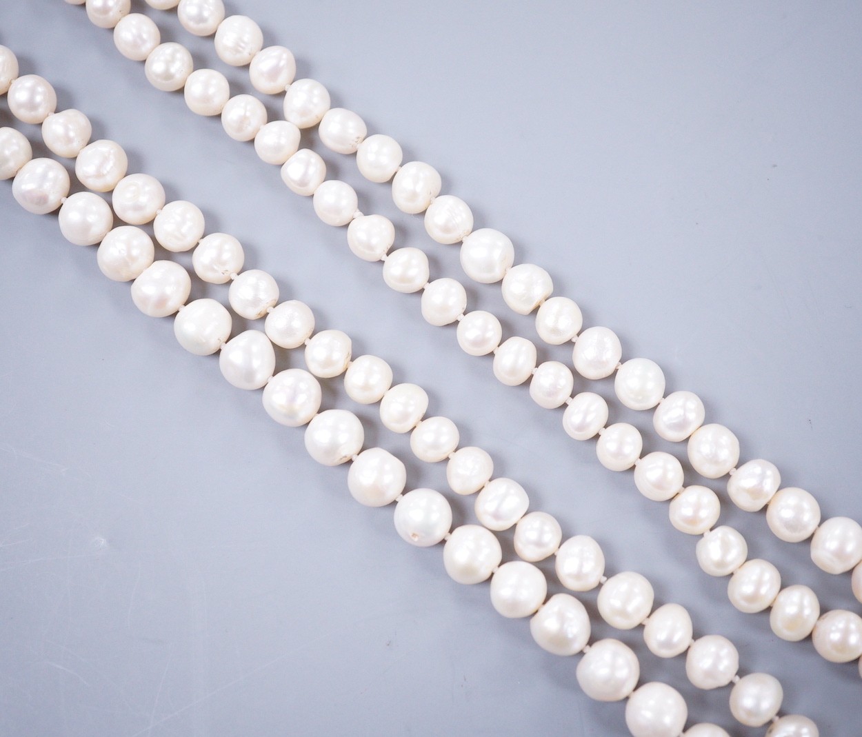 A long single strand freshwater pearl necklace, 121cm.